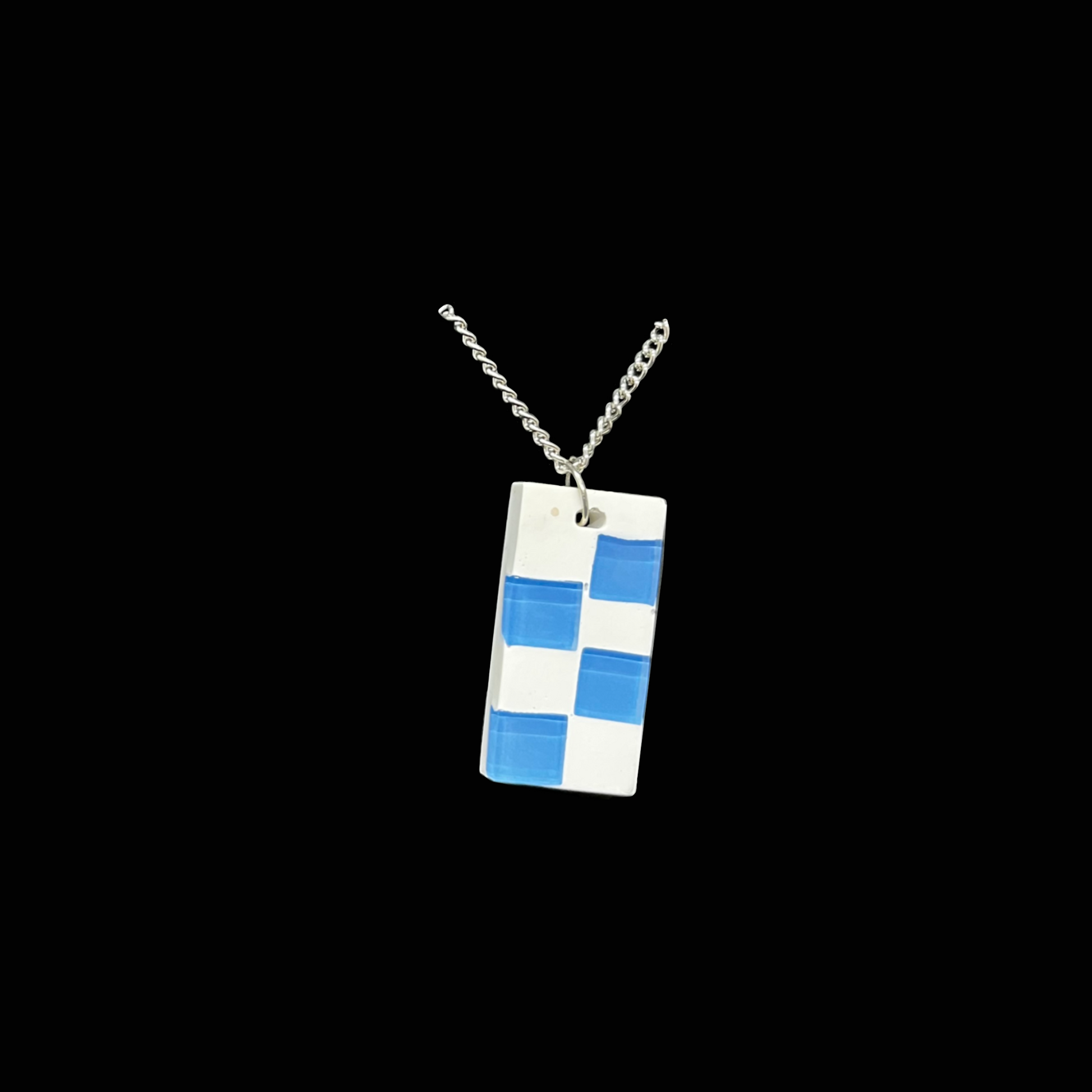 Handgjort halsband med blå-vitt rutmönster i modern, grafisk design. Stilrent och unikt smycke för alla tillfällen.